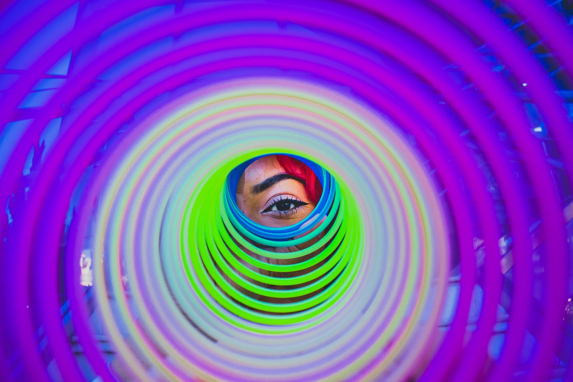 person looking through a slinky toy